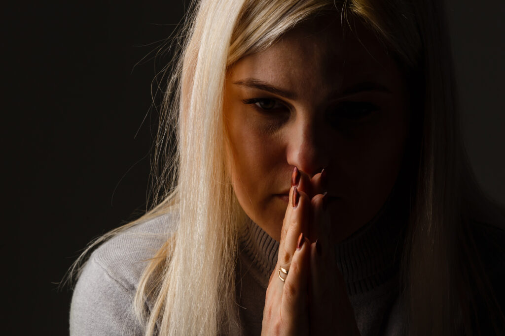 Woman praying because prayer is a powerful tool 